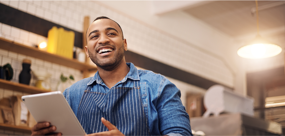 Small business owner using tablet representing business management and insurance needs in California